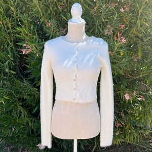 soft white cardigan with gold colored buttons